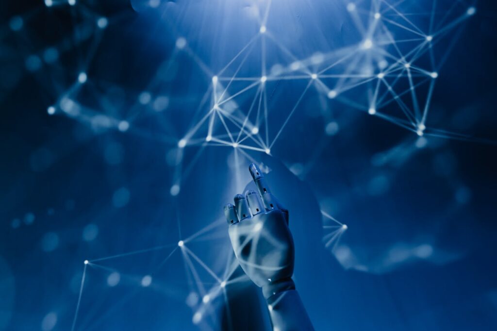 Crafting Captivating Headlines: Your awesome post title goes here A robotic hand reaching into a digital network on a blue background, symbolizing AI technology.